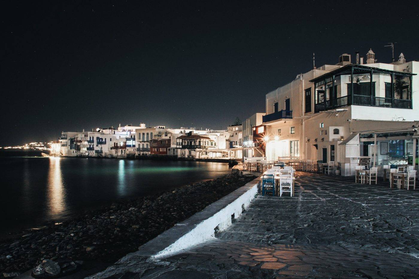 Little Venice at night, its waterfront lights reflected in the sea, seen from the seafront path