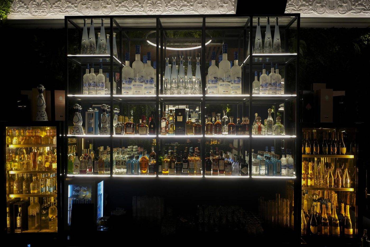 The back bar of WE ❤ MYK Club, with lit shelves of bottles