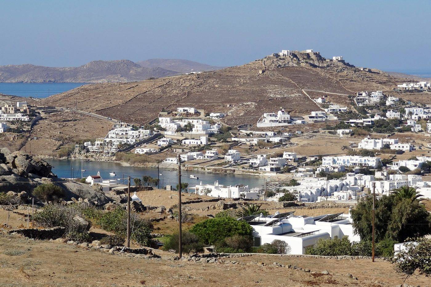 The bay of Ornos on the south coast of Mykonos, with white houses down to the water